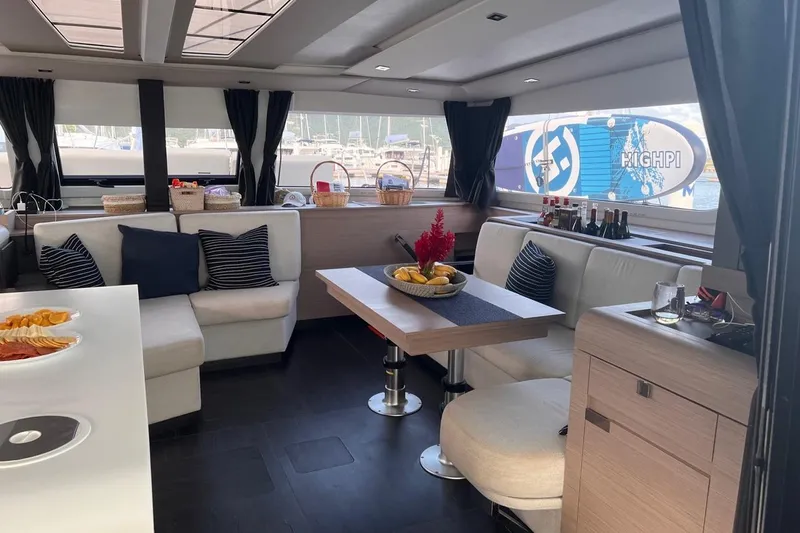 Endless Summer Yacht Photos Pics Luxurious interior of 2022 Fountaine Pajot Aura 51 Catamaran with elegant seating and dining area.