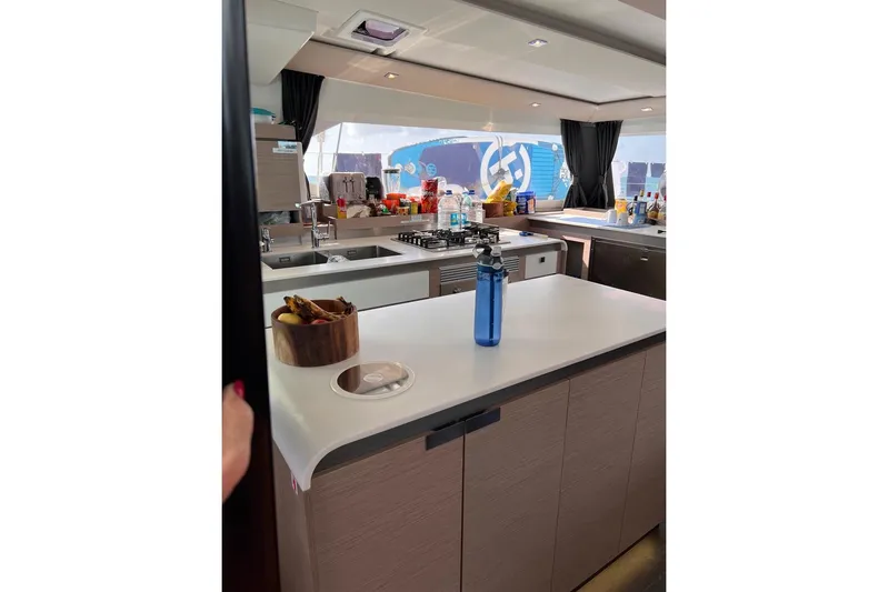 Endless Summer Yacht Photos Pics Modern kitchen interior of 2022 Fountaine Pajot Aura 51 Catamaran, featuring sleek countertops and appliances.