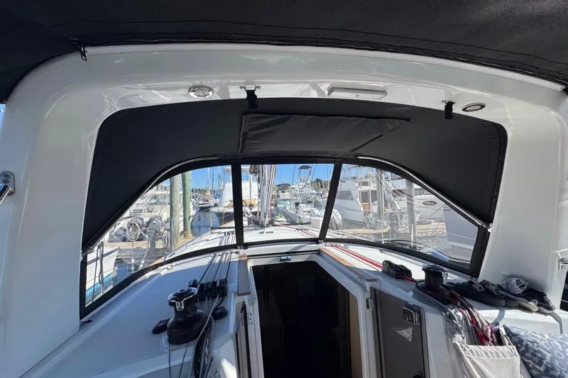 At Last Yacht Photos Pics Interior view of 2023 Beneteau Oceanis 38.1 sailboat cockpit with marina background.