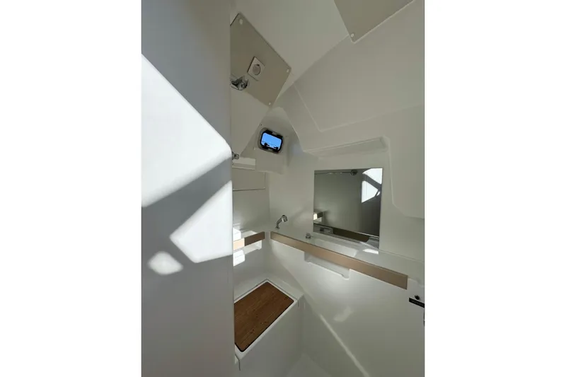 At Last Yacht Photos Pics Interior of 2023 Beneteau Oceanis 38.1 yacht bathroom with modern fixtures and natural light.