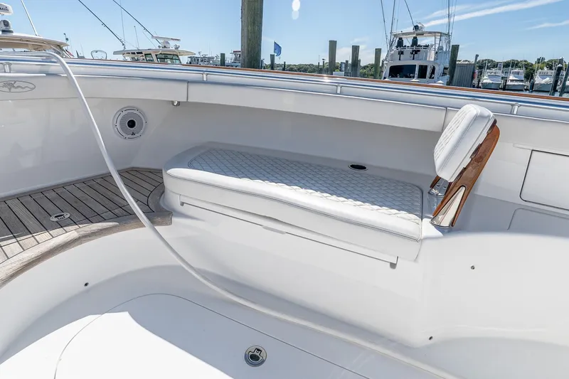  Yacht Photos Pics 2023 Valhalla Boatworks V-46 interior with cushioned seating and wooden accents.