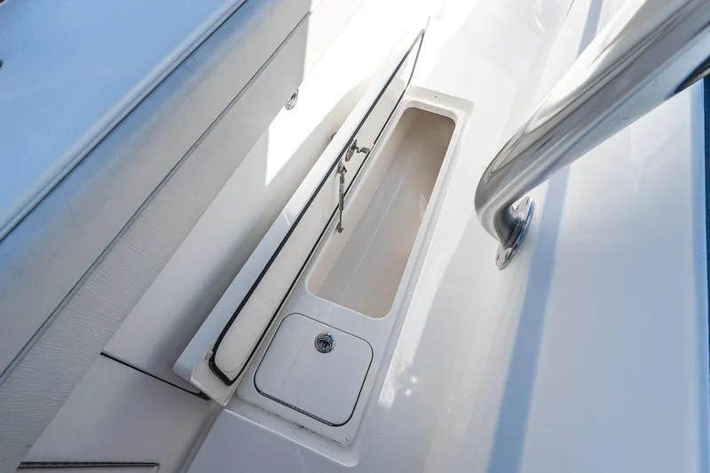  Yacht Photos Pics 2023 Valhalla Boatworks V-46 storage compartment with sleek design and stainless steel railing.