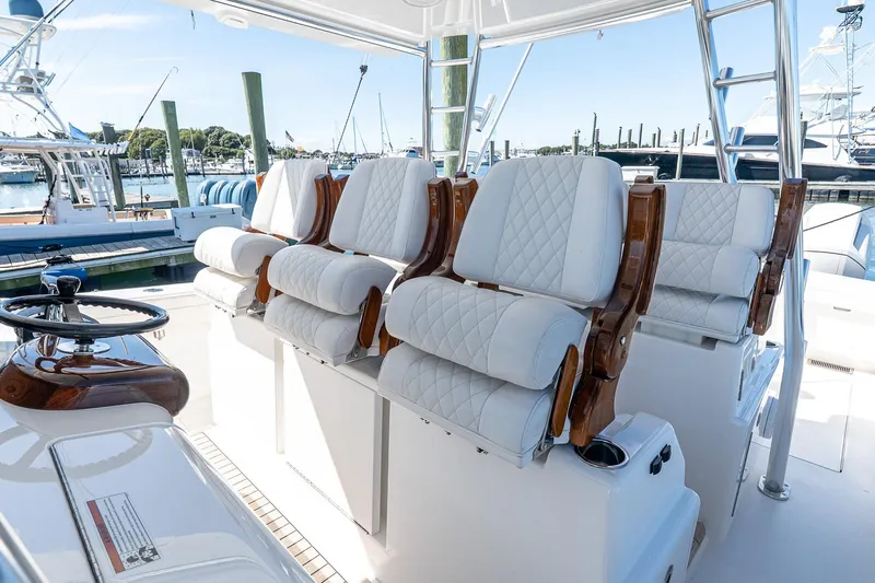  Yacht Photos Pics 2023 Valhalla Boatworks V-46 helm with luxurious white seating and polished wood accents.