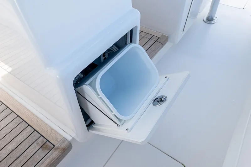  Yacht Photos Pics 2023 Valhalla Boatworks V-46, open storage compartment on deck with wooden accents.