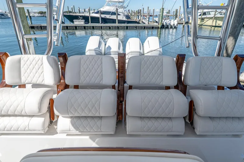  Yacht Photos Pics 2023 Valhalla Boatworks V-46 luxury seating with quilted upholstery, docked at marina.