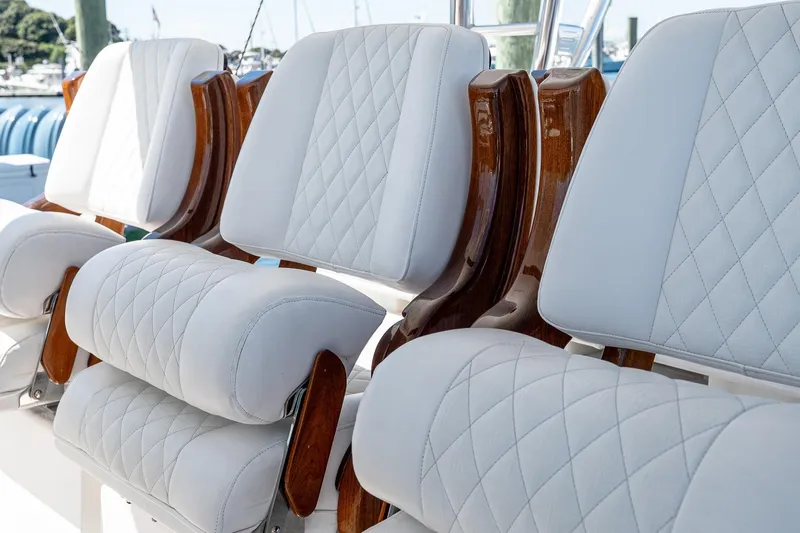  Yacht Photos Pics Luxurious seating on 2023 Valhalla Boatworks V-46 with quilted white upholstery and wooden accents.