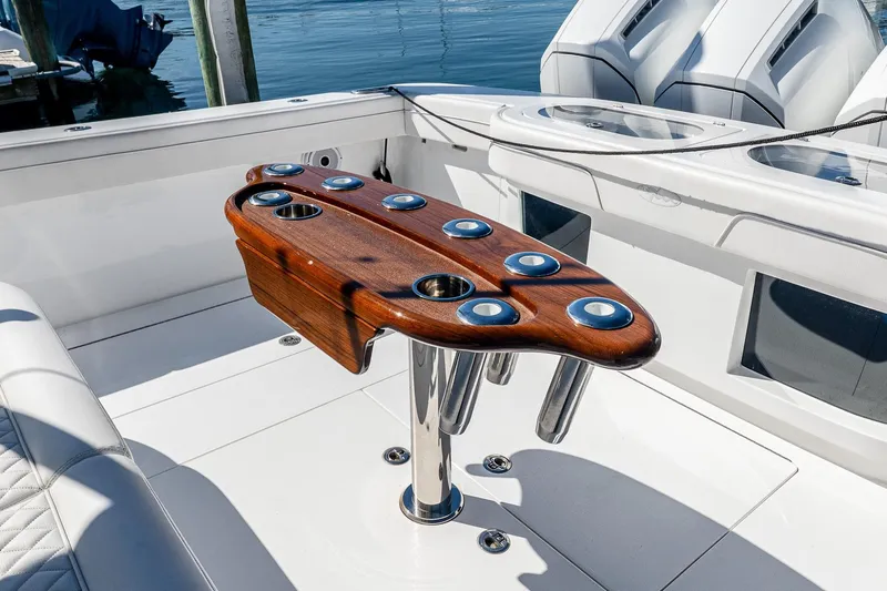  Yacht Photos Pics 2023 Valhalla Boatworks V-46 cockpit with wooden rod holder and white seating.