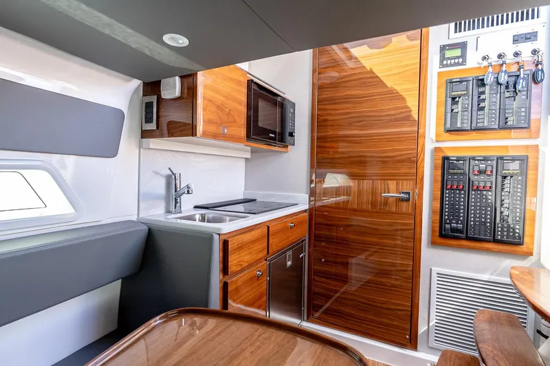 Yacht Photos Pics Luxurious interior of 2023 Valhalla Boatworks V-46 with modern kitchen and control panels.