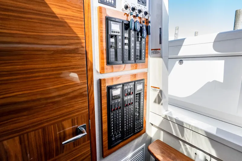  Yacht Photos Pics 2023 Valhalla Boatworks V-46 interior with control panels and wooden finish.
