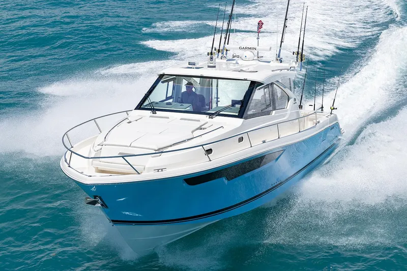  Yacht Photos Pics Manufacturer Provided Image: 2024 Pursuit OS 445 Offshore boat cruising on blue ocean water.