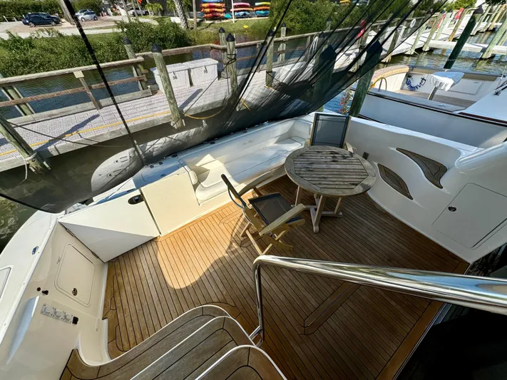 Club Life Yacht Photos Pics 2008 Sea Ray 58 Sedan Bridge yacht deck with wooden flooring and seating area.