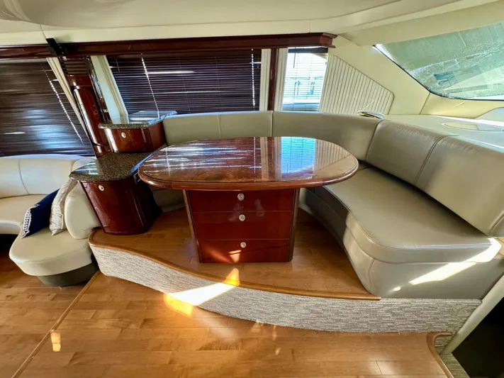Club Life Yacht Photos Pics Luxurious interior of 2008 Sea Ray 58 Sedan Bridge with elegant seating and wooden table.