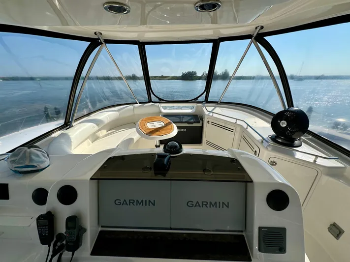 Club Life Yacht Photos Pics 2008 Sea Ray 58 Sedan Bridge helm with Garmin navigation, overlooking serene waters.