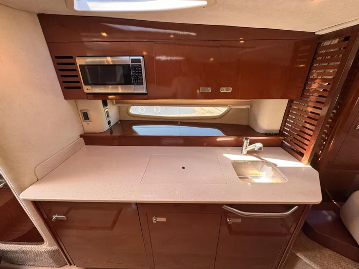  Yacht Photos Pics Luxurious 2010 Sea Ray 370 Sundancer yacht kitchen with microwave and sink.