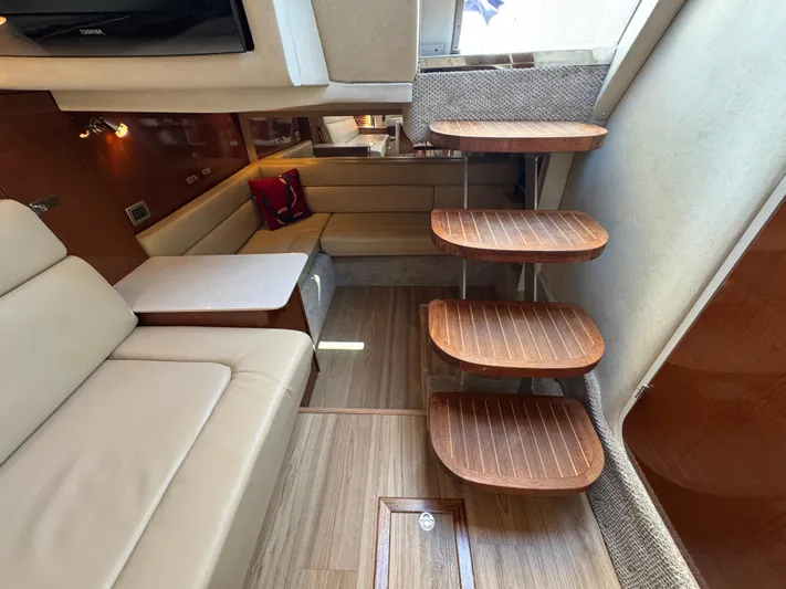  Yacht Photos Pics Luxurious interior of 2010 Sea Ray 370 Sundancer yacht with wooden steps and beige seating.