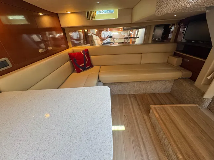  Yacht Photos Pics Luxurious interior of 2010 Sea Ray 370 Sundancer with beige seating and wooden flooring.