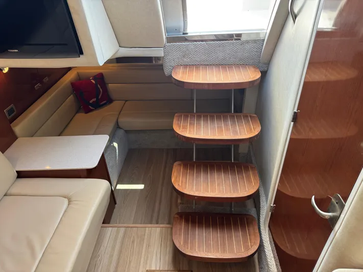  Yacht Photos Pics Interior of 2010 Sea Ray 370 Sundancer with wooden steps and cozy seating area.