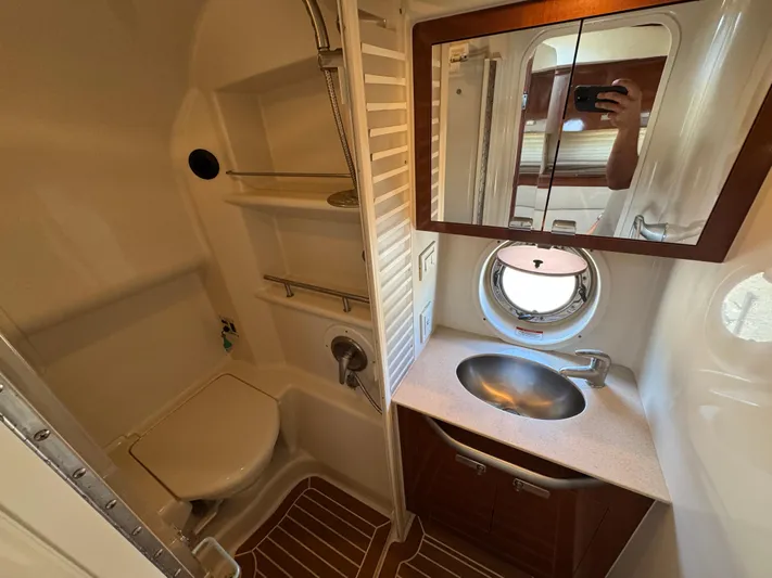  Yacht Photos Pics Bathroom interior of 2010 Sea Ray 370 Sundancer yacht with sink, mirror, and toilet.