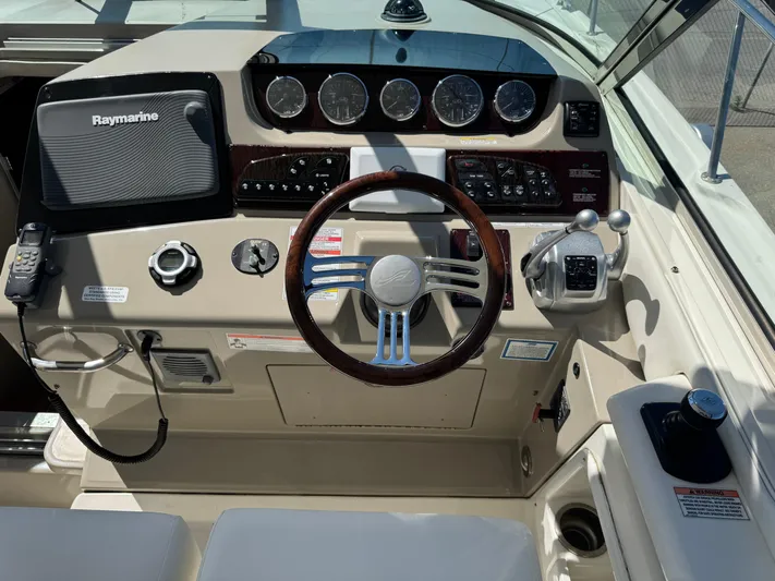  Yacht Photos Pics Cockpit of 2010 Sea Ray 370 Sundancer with steering wheel and navigation controls.