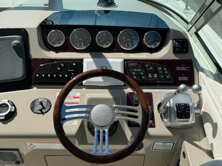  Yacht Photos Pics Dashboard of a 2010 Sea Ray 370 Sundancer boat with steering wheel and controls.