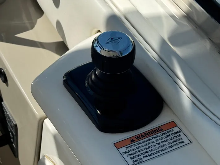  Yacht Photos Pics Joystick control on 2010 Sea Ray 370 Sundancer boat dashboard with warning label.