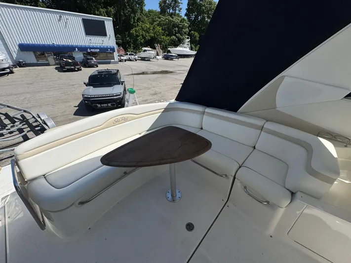  Yacht Photos Pics 2010 Sea Ray 370 Sundancer yacht with white seating and wooden table on deck.