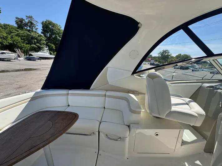  Yacht Photos Pics Interior of 2010 Sea Ray 370 Sundancer yacht with white seating and wooden table.