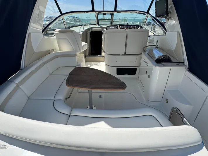  Yacht Photos Pics Luxurious interior of 2010 Sea Ray 370 Sundancer yacht with seating and table.