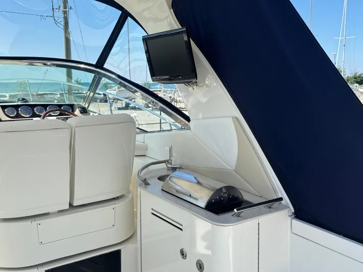  Yacht Photos Pics Interior of 2010 Sea Ray 370 Sundancer with helm, sink, and TV.