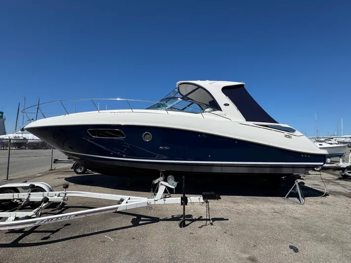  Yacht Photos Pics 2010 Sea Ray 370 Sundancer boat on trailer under clear blue sky.
