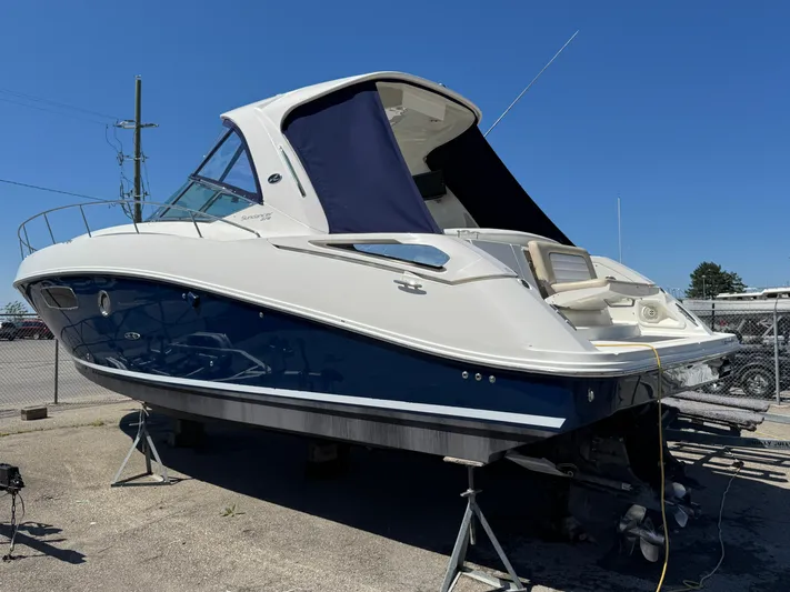  Yacht Photos Pics 2010 Sea Ray 370 Sundancer boat on stands, blue and white exterior, sunny day.