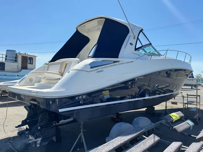  Yacht Photos Pics 2010 Sea Ray 370 Sundancer boat on dry dock under clear blue sky.