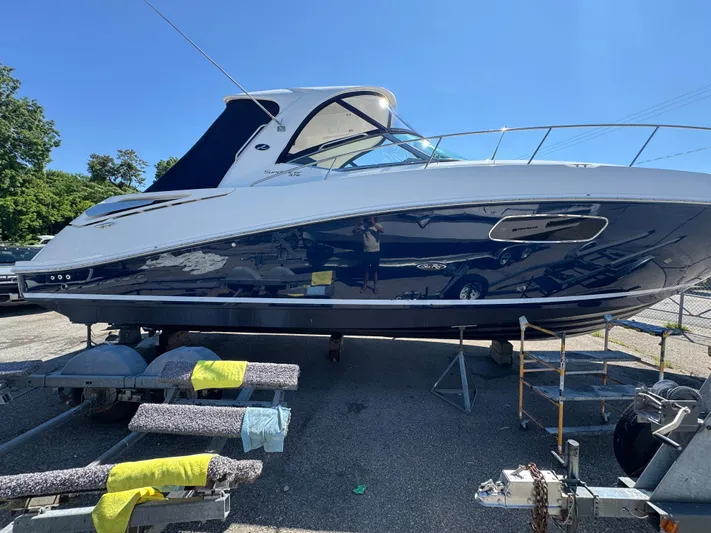  Yacht Photos Pics 2010 Sea Ray 370 Sundancer yacht on trailer, parked outdoors under clear blue sky.
