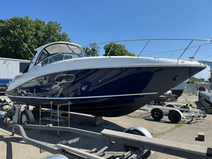  Yacht Photos Pics 2010 Sea Ray 370 Sundancer boat on trailer, parked outdoors under clear blue sky.