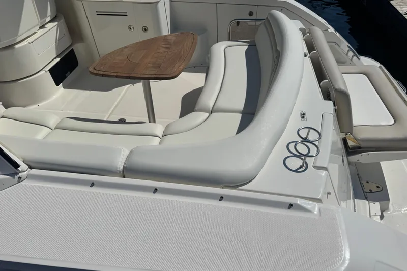  Yacht Photos Pics 2010 Sea Ray 370 Sundancer boat interior with white seating and wooden table.