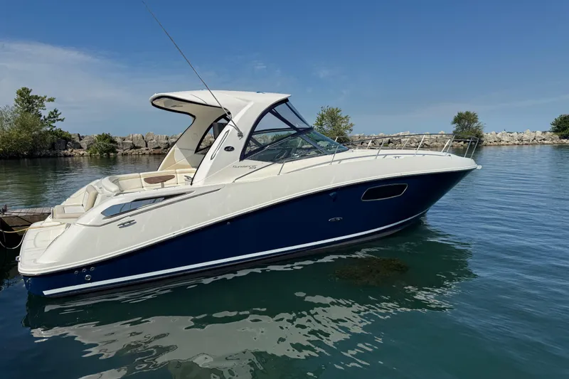  Yacht Photos Pics 2010 Sea Ray 370 Sundancer boat on calm water, clear sky background.