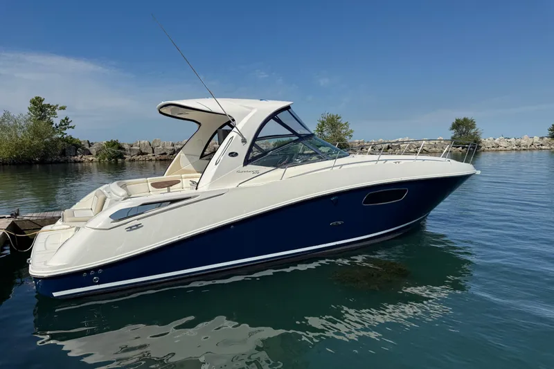  Yacht Photos Pics 2010 Sea Ray 370 Sundancer yacht docked on calm water under clear blue sky.
