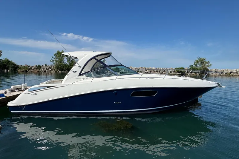  Yacht Photos Pics 2010 Sea Ray 370 Sundancer yacht docked on calm water under clear blue sky.
