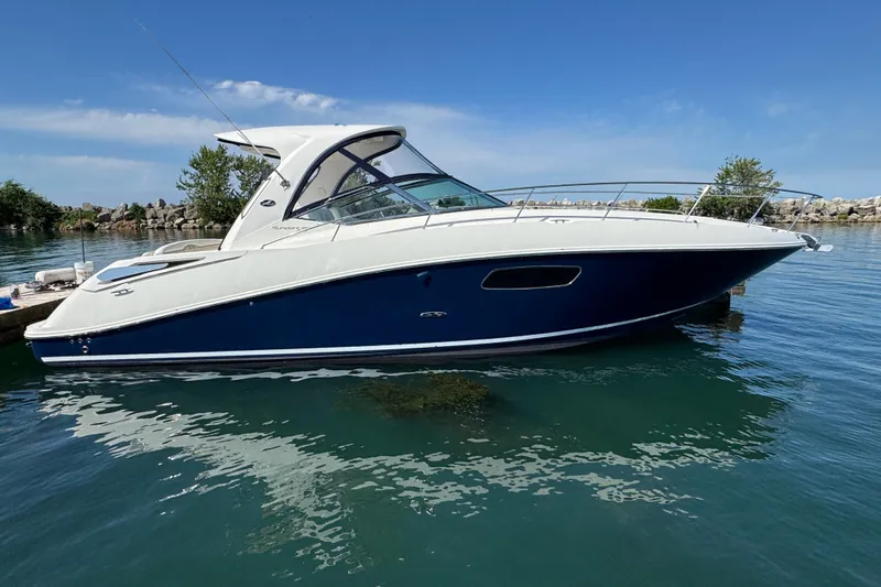  Yacht Photos Pics 2010 Sea Ray 370 Sundancer yacht on calm water, clear sky background.