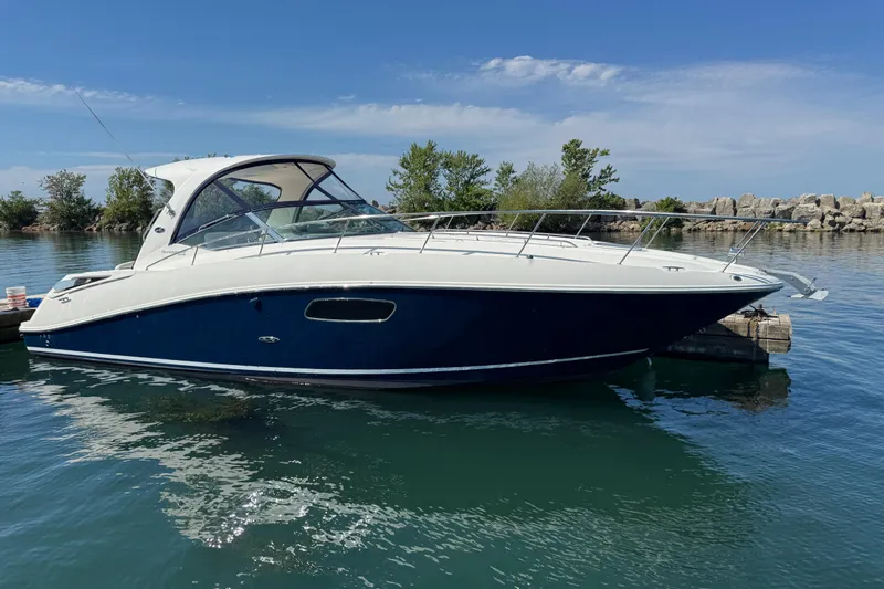  Yacht Photos Pics 2010 Sea Ray 370 Sundancer yacht docked on calm water, clear sky background.