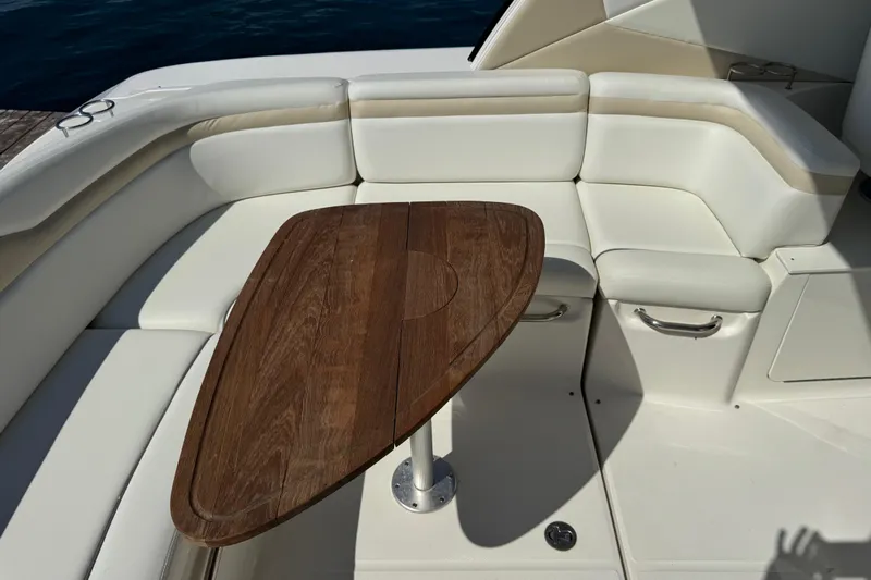  Yacht Photos Pics Luxurious seating area on a 2010 Sea Ray 370 Sundancer with wooden table.