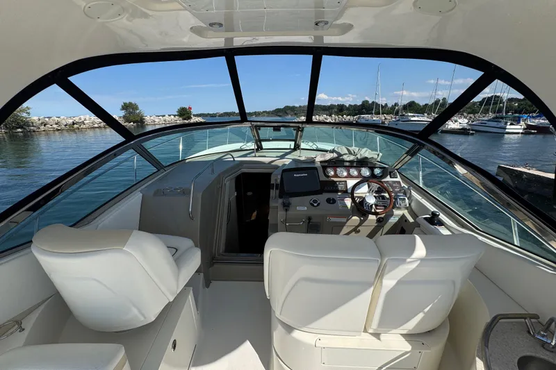  Yacht Photos Pics Interior view of 2010 Sea Ray 370 Sundancer yacht cockpit with scenic marina backdrop.