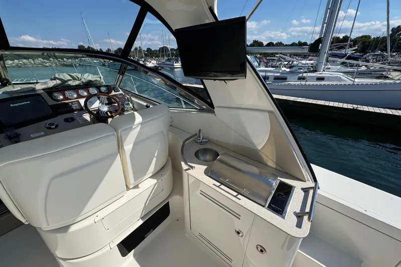  Yacht Photos Pics Cockpit view of 2010 Sea Ray 370 Sundancer with helm and kitchenette.