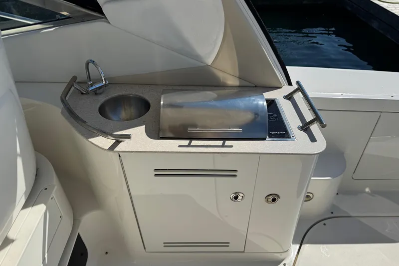  Yacht Photos Pics Outdoor kitchenette on a 2010 Sea Ray 370 Sundancer yacht with sink and grill.