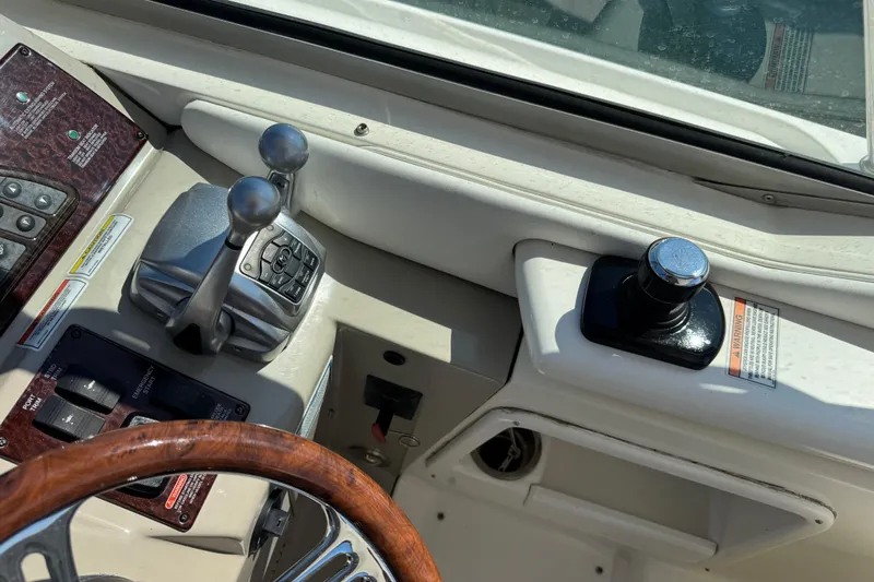  Yacht Photos Pics Control panel of a 2010 Sea Ray 370 Sundancer boat with steering wheel and throttle levers.