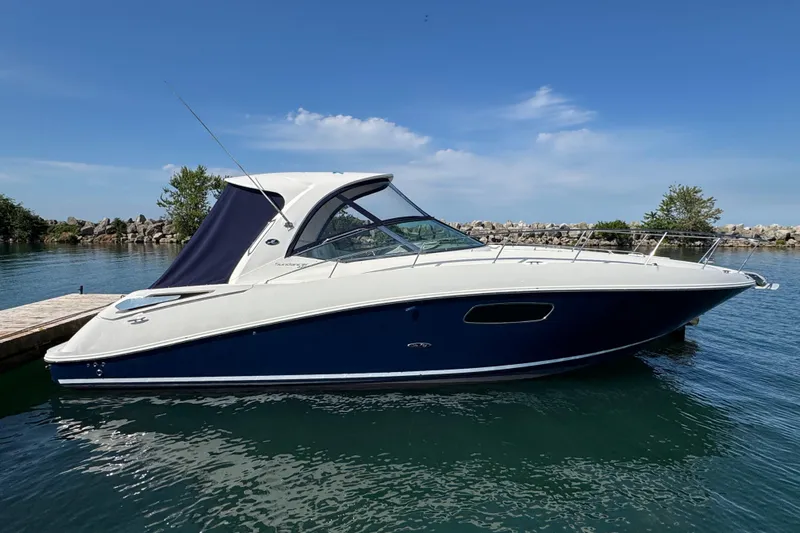  Yacht Photos Pics 2010 Sea Ray 370 Sundancer yacht docked on calm water under clear blue sky.