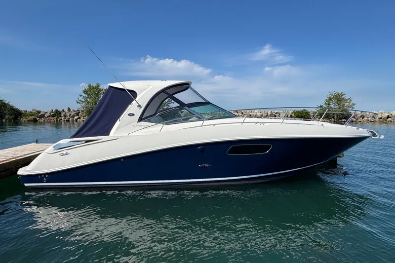  Yacht Photos Pics 2010 Sea Ray 370 Sundancer boat docked on calm water under a clear blue sky.