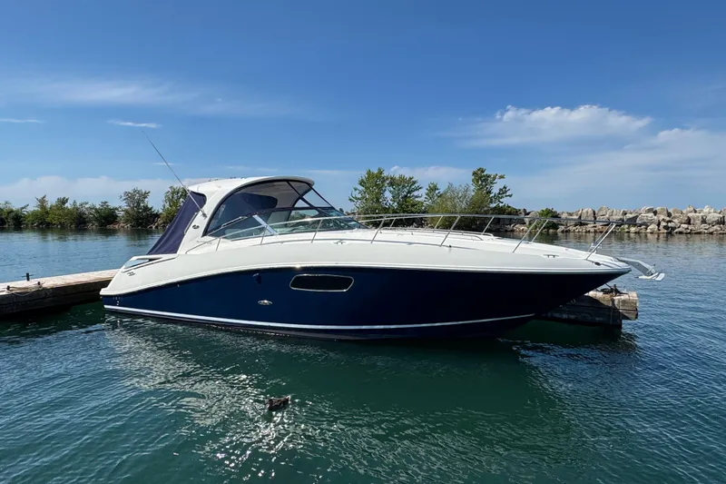  Yacht Photos Pics 2010 Sea Ray 370 Sundancer yacht docked on a sunny day, calm waters.