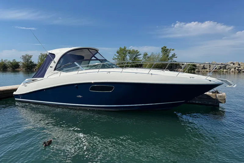  Yacht Photos Pics 2010 Sea Ray 370 Sundancer docked on calm water under a clear blue sky.