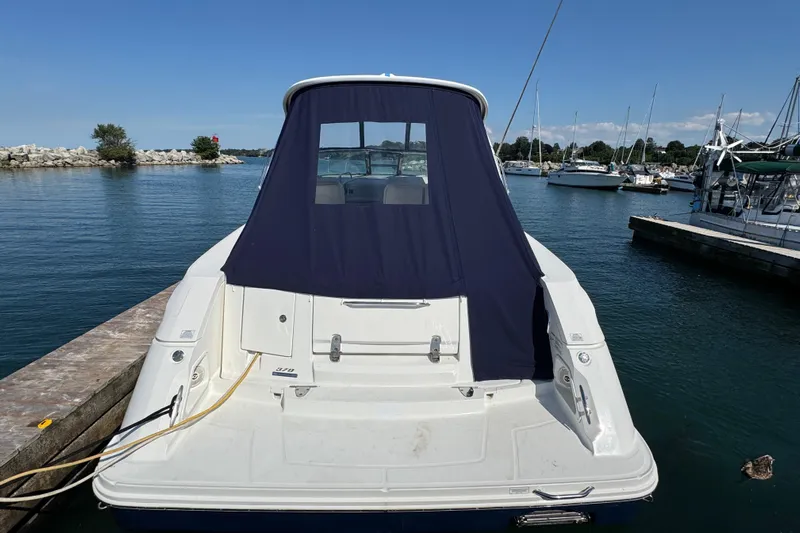 Yacht Photos Pics 2010 Sea Ray 370 Sundancer docked at marina, rear view with blue cover.